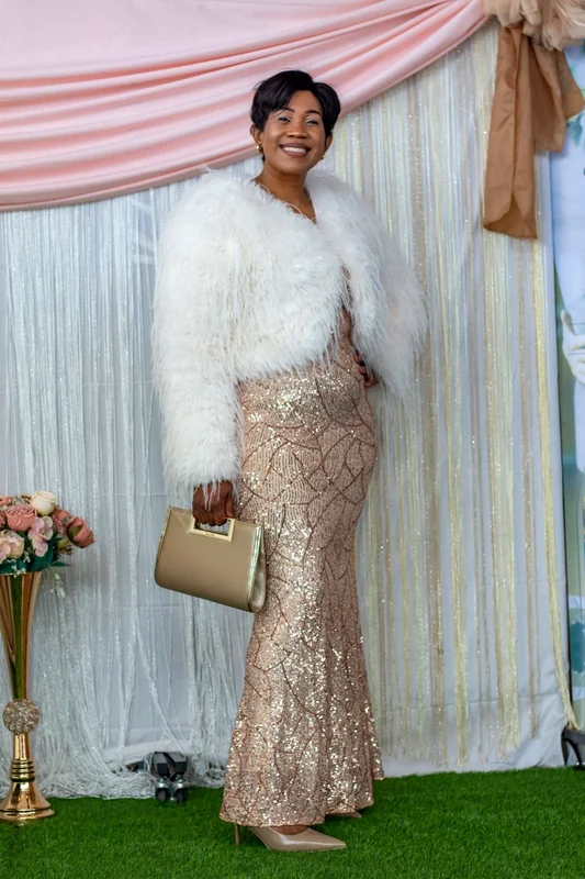 Woman smiling at a ministry photo backdrop