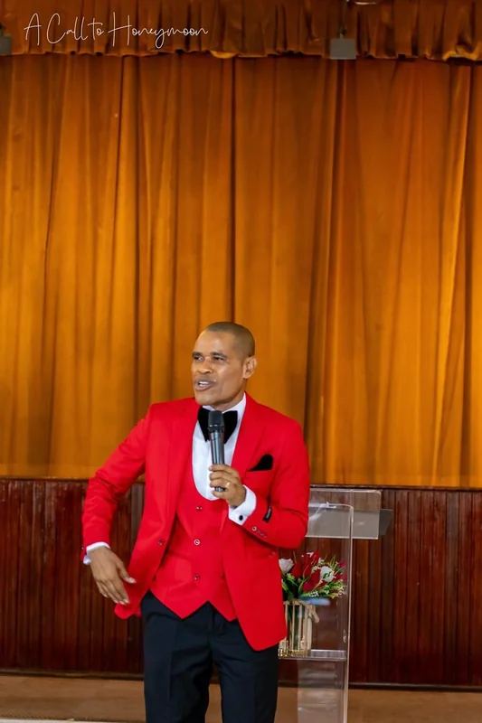 Pastor Phatudi Molapo teaching in a red suit