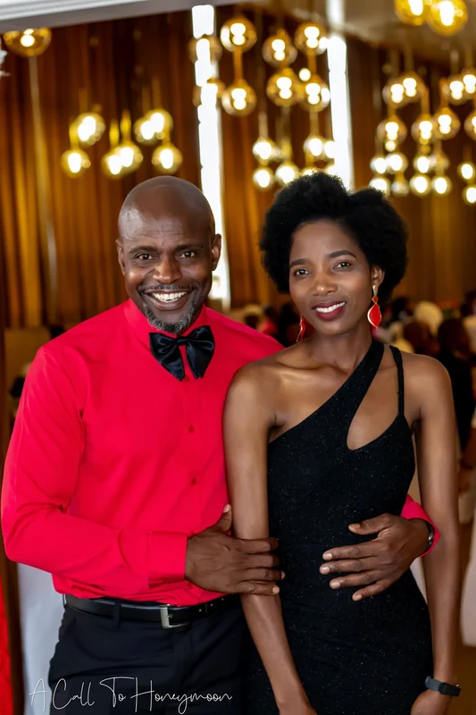 Pastor in red standing with a smiling woman at a ministry event