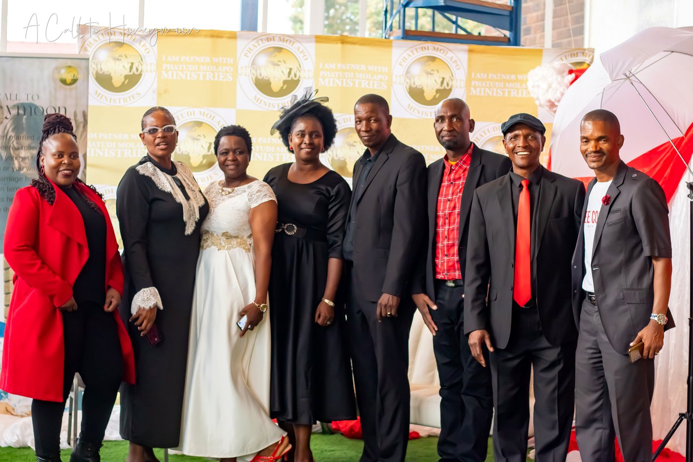 Ministry guests posing together at a photo backdrop