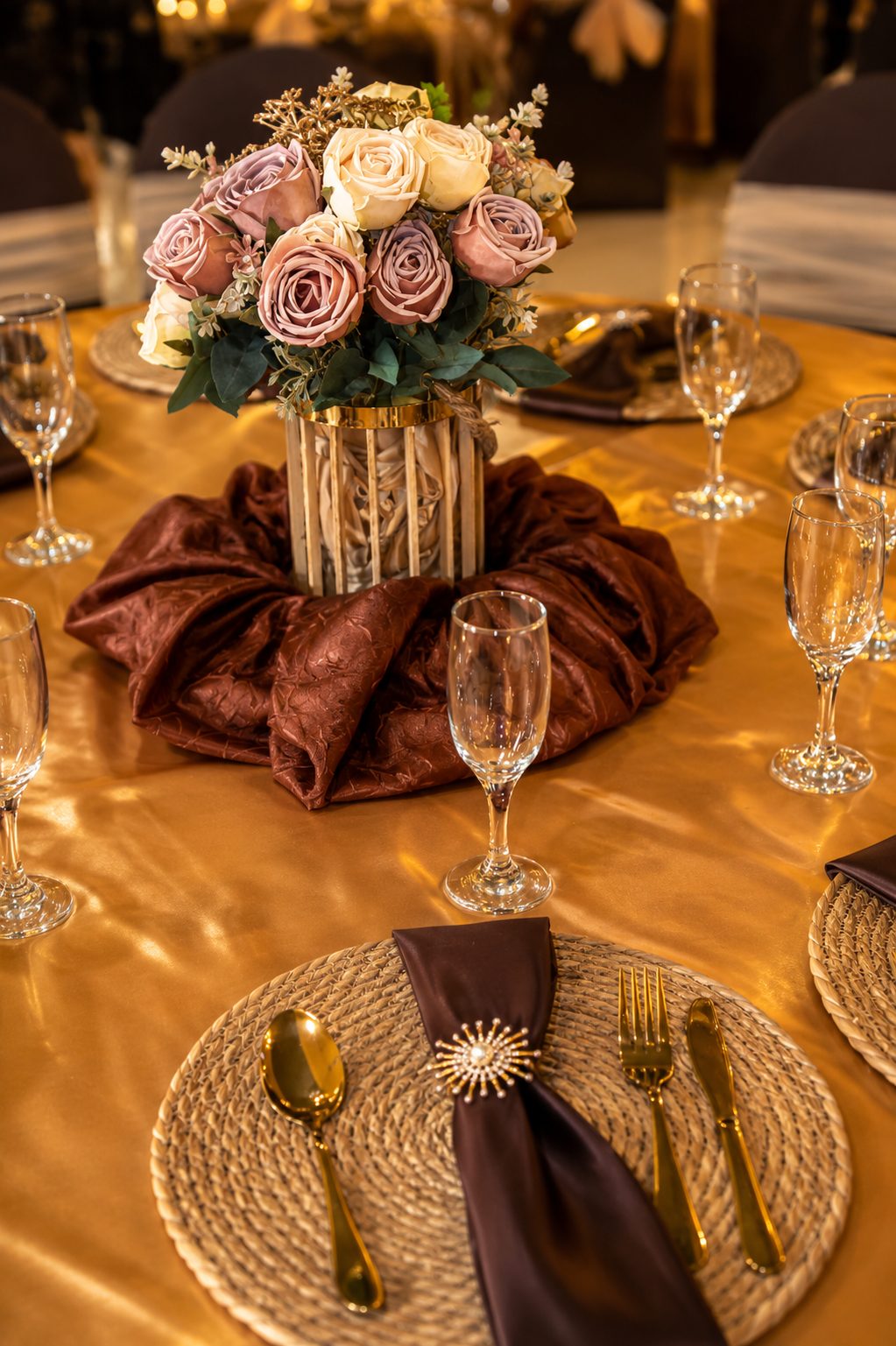 Close floral centerpiece with gold tableware at a ministry celebration