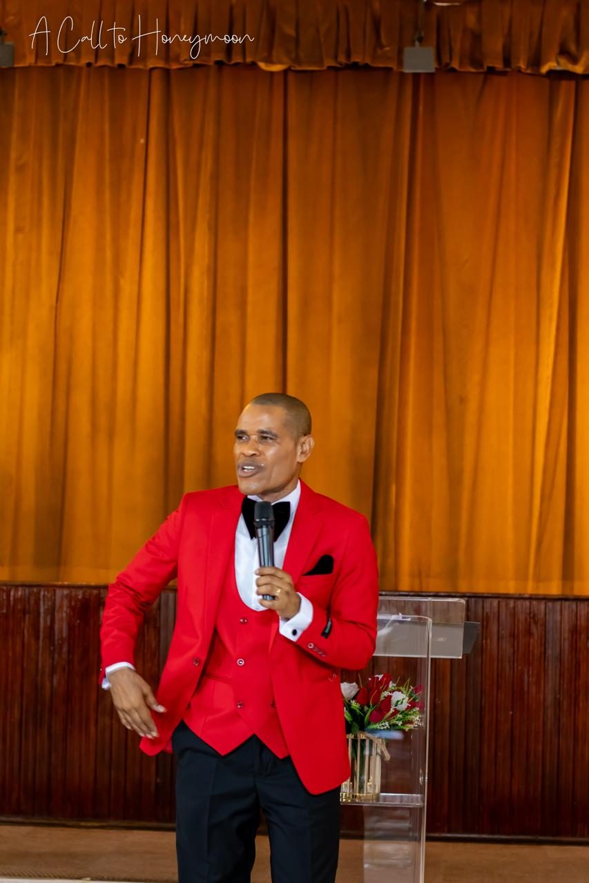 Pastor Phatudi Molapo teaching in a red suit